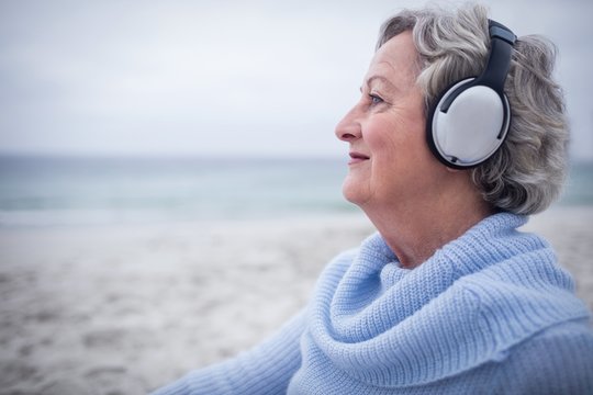 Senior woman listening to music on headphone