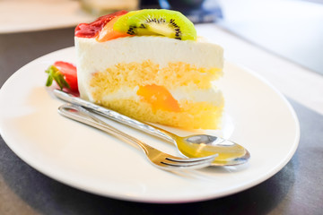 Cheese cake and mix fruits on white dish