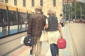 Old couple travel in the city