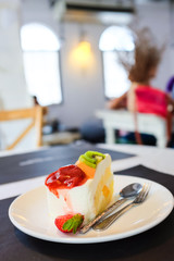 Cheese cake and mix fruits on white dish