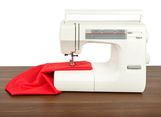 Sewing machine and red fabric isolated on white