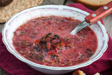 Vegetarian soup with mushrooms, plums and sour cream, horizontal