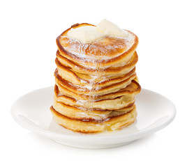 Stack of delicious pancakes with butter on plate isolated on white background.