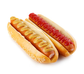Classic hot dogs with mustard and ketchup close-up on a white background. Fast food.