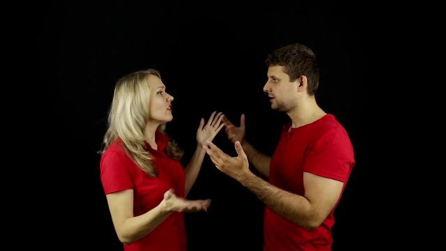 Man and woman swear. Family quarrel. Young couple quarrel. Conflict. Dispute. Quarrel. Black background