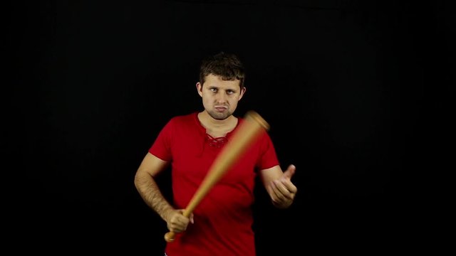 Man with baseball bat. Bully. Bandit. Crime. Racket. Bouncer. Guy with bat. Black background.
