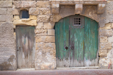 Big and small old gates in a fishing village Marsaxlokk at island Malta