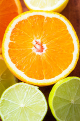Close shot of various citrus fruits. Grapefruits, oranges, limes, lemons. Vertical view.