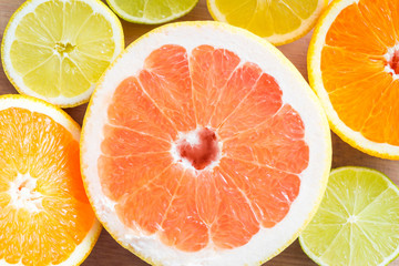 Fototapeta na wymiar Top view of various citrus fruits. Grapefruits, oranges, limes, lemons. Macro shot.