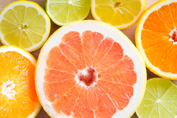 Fototapeta na wymiar Top view of various citrus fruits. Grapefruits, oranges, limes, lemons. Macro shot.