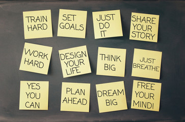 many sticky notes attached to blackboards with text