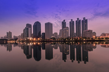 Cityscape of Benjakitti park Bangkok city downtown at sunrise wi
