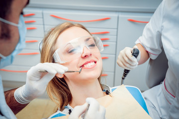 Young smiled woman at the dentist