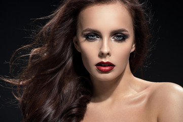 Fototapeta premium Closeup portrait of brunette woman on black background