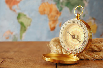 traveler vintage compass and rope on wooden table