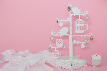 Baby pink background with candle and charms