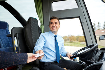 bus driver taking ticket or card from passenger