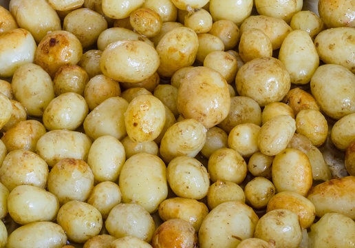 freshly cooked new potatoes covered in melted butter.