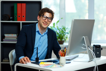 Fototapeta premium Handsome young man working from home office