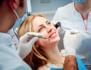 Young smiled woman at the dental office