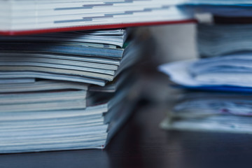 Accounting and taxes. Pile of magazine, notebook and books close