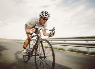 Fototapeta Cyclist pedaling on a racing bike outdoor obraz