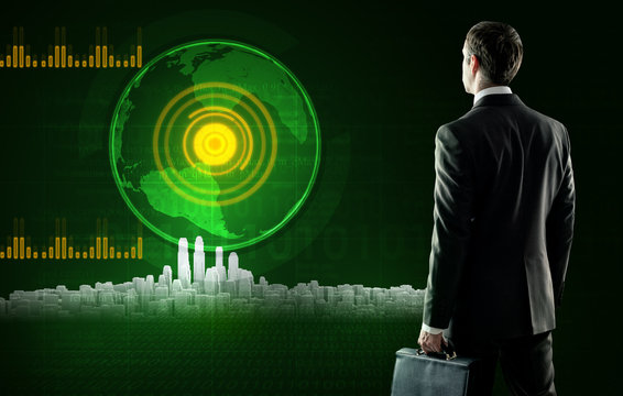 Business man stands near virtual screen with city