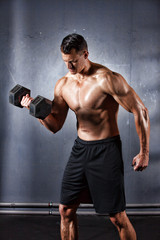 Fototapeta na wymiar Man holding a dumbbell doing a fitness workout
