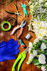 Garden tools, Tools for floristics and flowers on a wooden table.