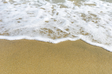 Fototapeta na wymiar Sea foam on the sand.