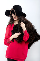 beautiful girl in hat and with fur