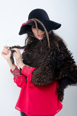 beautiful girl in hat and with fur