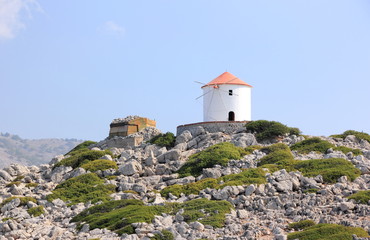Fototapeta na wymiar Traditional windmill at Panormitis on Symi Island. Greece, Europe.