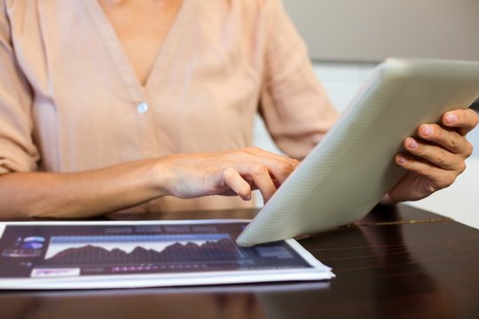Cropped image of businesswoman using digital tablet