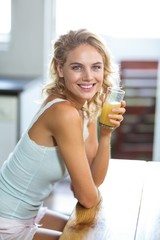 Portrait of smiling woman holding juice glass