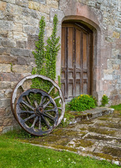 Obraz premium Cartwheels in courtyard, England