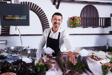 Mature man and fish market