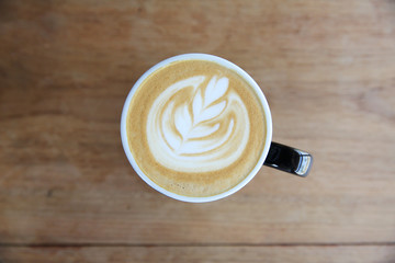 hot cappuccino coffee on wood background