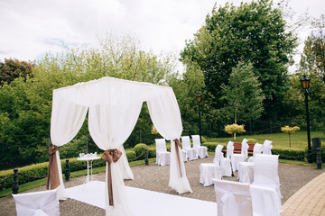 Decorations for the wedding ceremony in the park, Silk tent for the wedding ceremony for the newlyweds