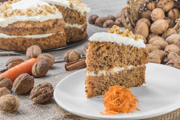 Slice of Carrot and Walnut Cake Topped with Cream  on Jute Backg