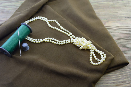 fabric of a thread and necklace