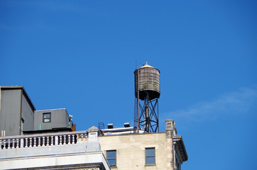 Water tower in city  with blue skies 