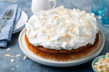 Three milk cake, tres leches cake with coconut. Traditional dessert of Latin America.