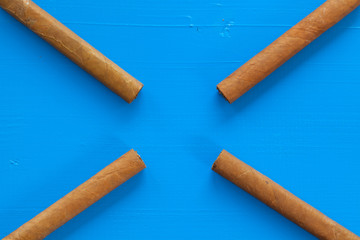 Detail of luxury Cuban cigars on the blue table