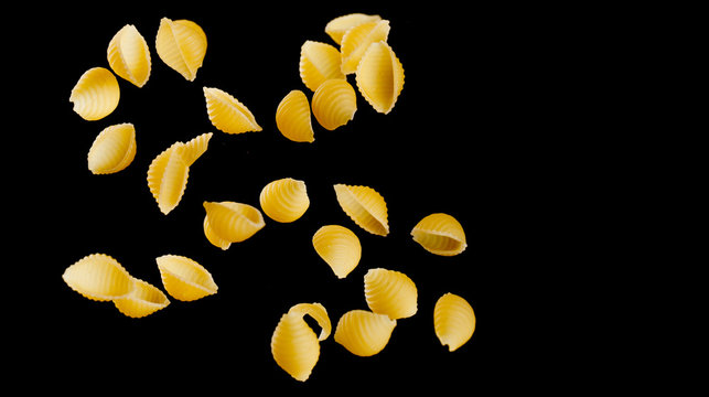 Download Falling Conchiglie Pasta Flying Yellow Raw Macaroni Over Black Background Buy This Stock Photo And Explore Similar Images At Adobe Stock Adobe Stock PSD Mockup Templates