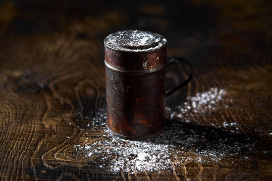 Flour sifter on wooden surface