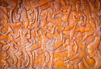 Native Thai style wood carving in public temple, vignette background