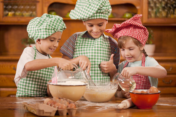 smiling kids make a mess in the kitchen