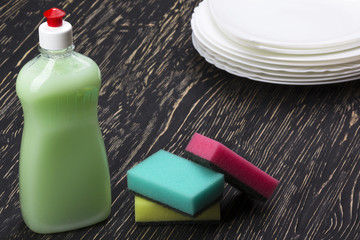 sponges, dishes and a bottle of detergent