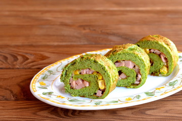 Omelet with spinach. Green scrambled eggs. Omelet stuffed with cheese, sausage and corn. Healthy meals slow. Simple eggs recipe